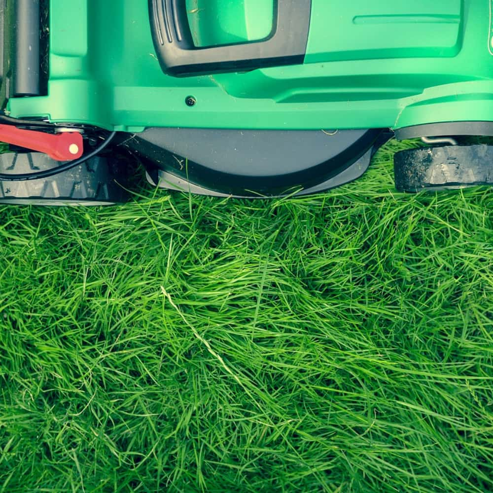 Close-up van een grasmaaier op een groen gazon